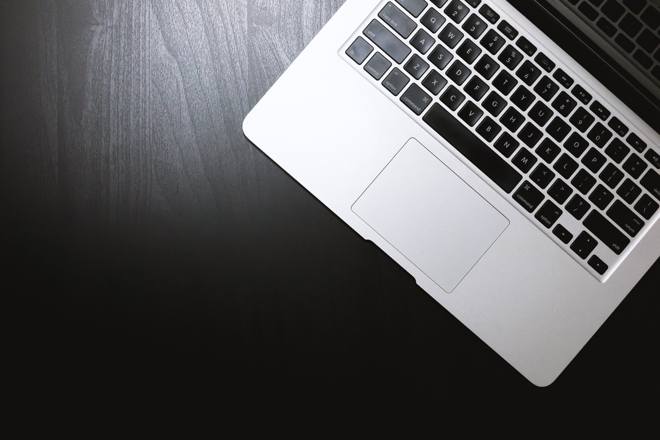 Laptop on Black Wooden Background